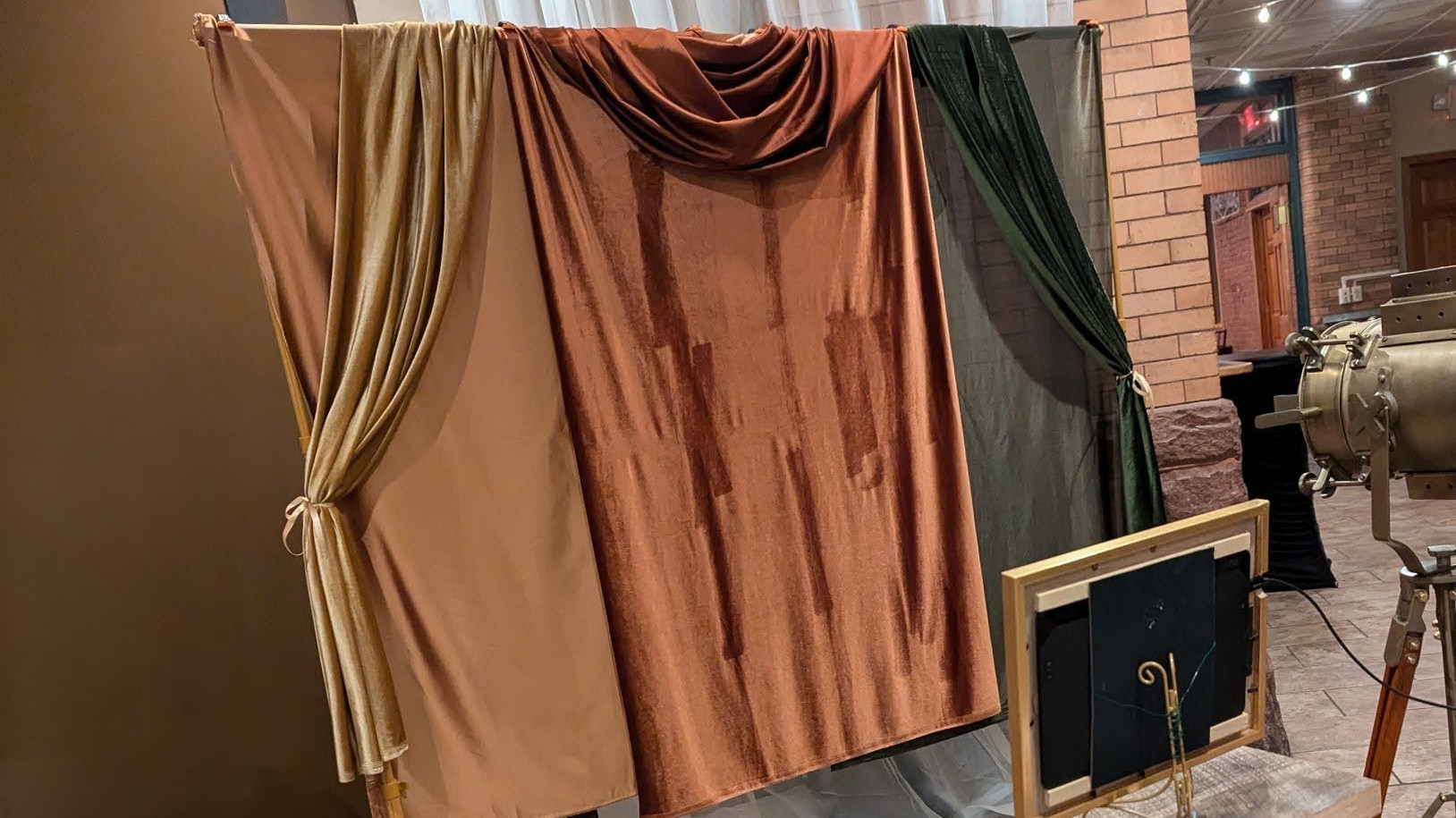 A fabric photo backdrop for a wedding